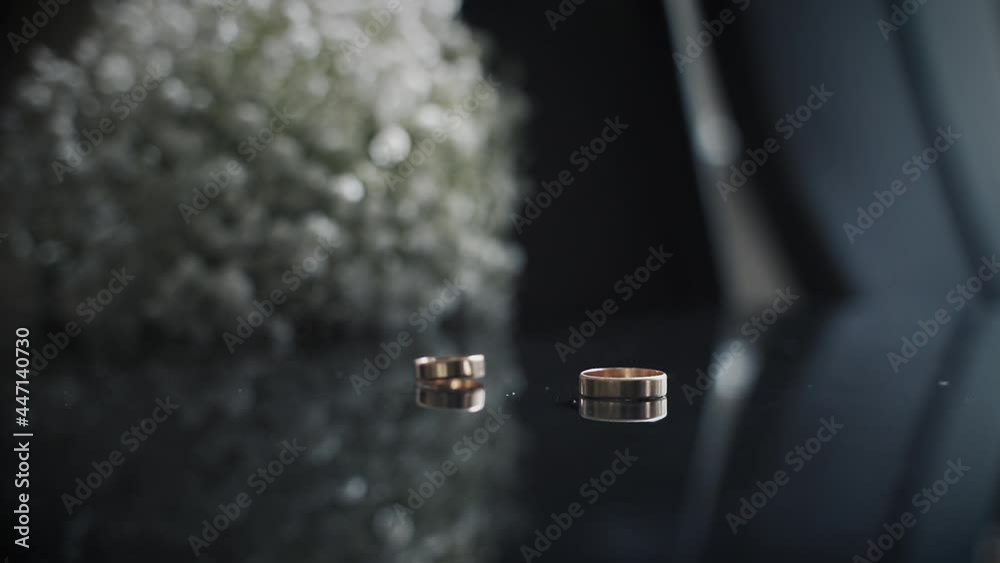 Wedding bouquet and jumping wedding ring on a dark table with reflection. Wedding bouquet and jumping wedding ring on a dark table with reflection.