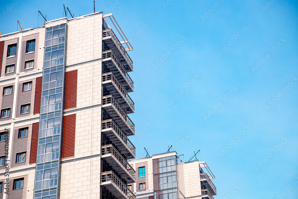 Modern apartment building site against blue sky