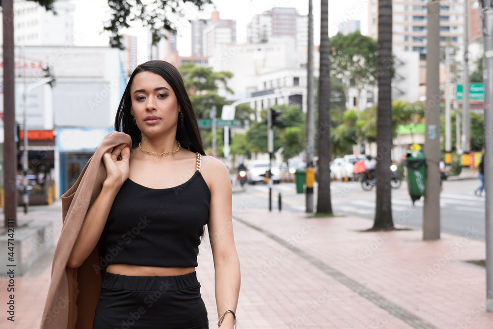 Latin woman walks in the city where she lives