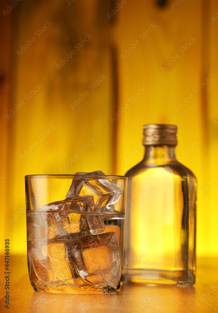 a glass full of liquid with ice cubes a glass full of liquid with ice cubes