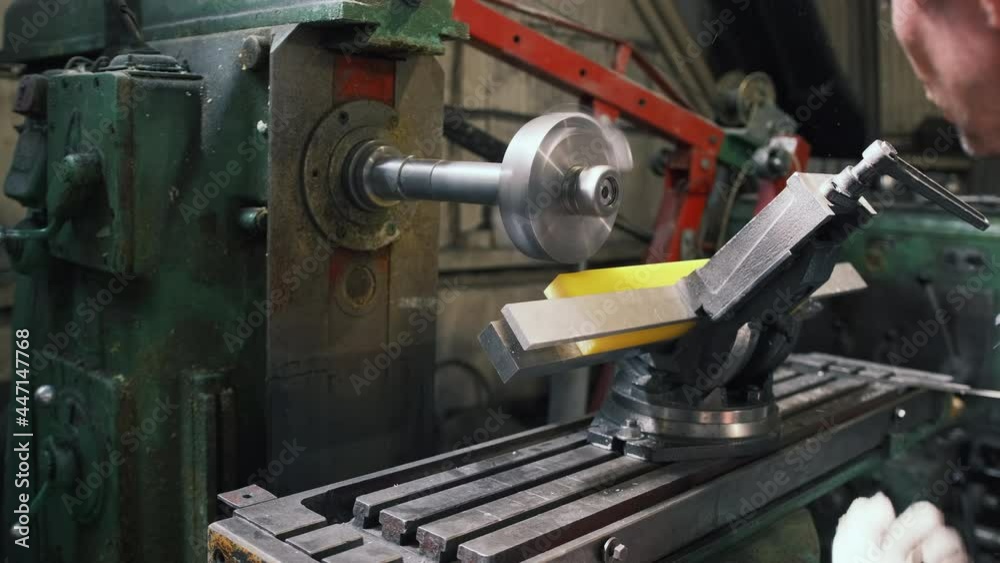 A worker in production processes a polyurethane part on a horizontal