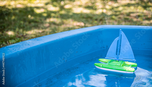 Toy boat in a children's pool photo