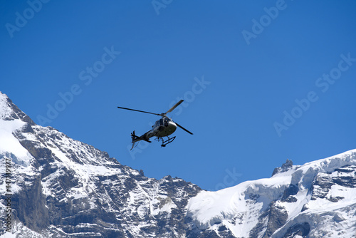 White transport helicopter at Lauterbrunnen on a sunny summer day with Jungfraujoch in the background. Photo taken July 20th, 2021, Lauterbrunnen, Switzerland. © Michael Derrer Fuchs