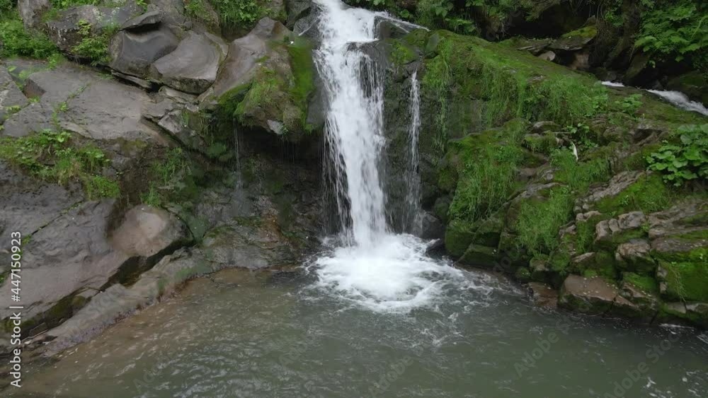 people travelers enjoying view of waterfall in carpathian mountains people travelers enjoying view of waterfall in carpathian mountains