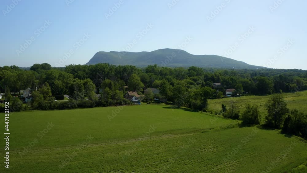 Aerial view of Mount Saint-Hilaire with a field in foreground from drone Aerial view of Mount Saint-Hilaire with a field in foreground from drone