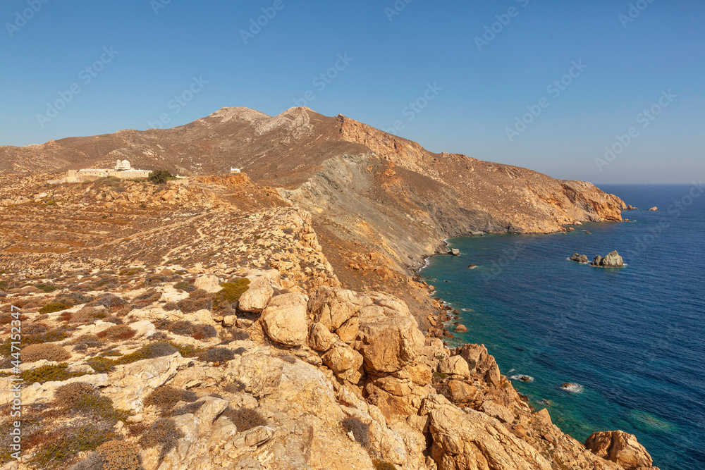 Rocky landscape with Monastery of Zoodochos Pigi or Panagia Kalamiotissa on Greek island Anafi in Cyclades, Greece
