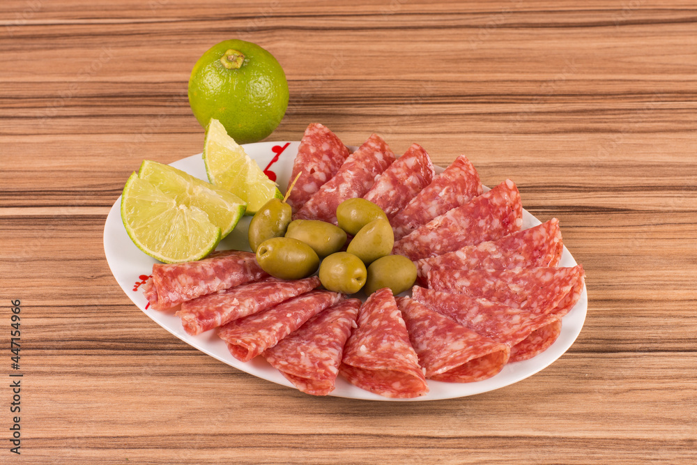 portion of salami on wooden background