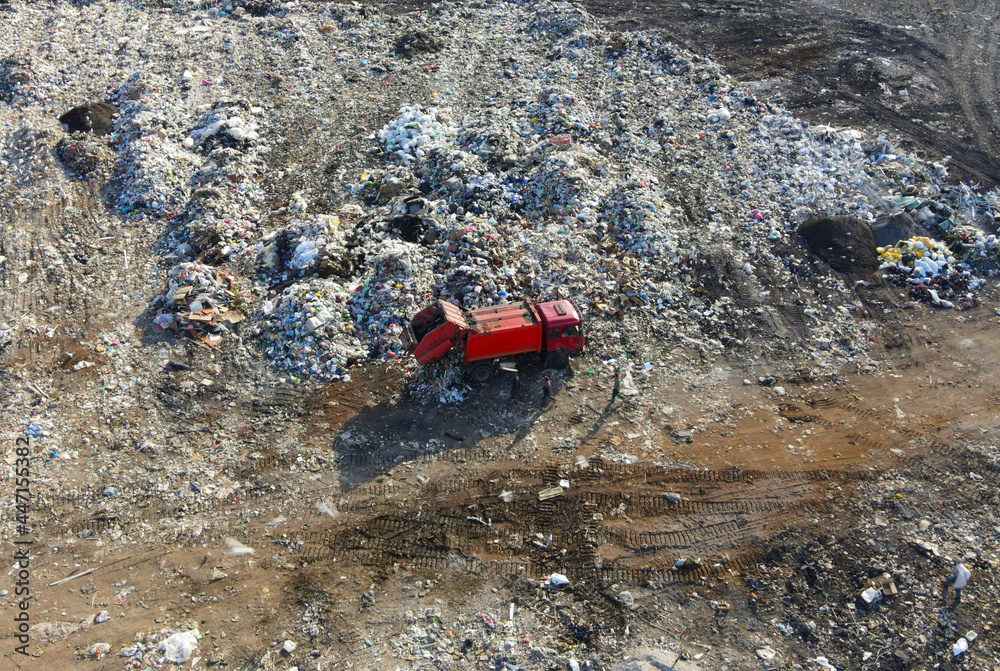 Garbage dump with food waste. Arial view of garbage truck unloads rubbish in landfill. Plastic rubbish dump. Reduce greenhouse gas emissions and methane emissions. Environmental protection
