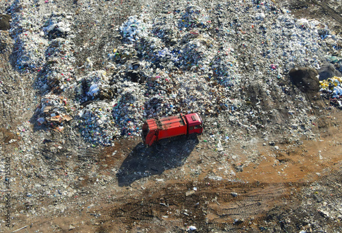 Garbage dump with food waste. Arial view of garbage truck unloads rubbish in landfill. Plastic rubbish dump. Reduce greenhouse gas emissions and methane emissions. Environmental protection