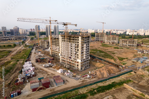 Crane during formworks. Aerial View of a large construction site. Tower cranes in action. Housing renovation concept. Construction the buildings and multi-storey residential homes