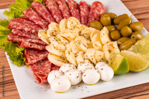 portion of cheese and salami on wooden background