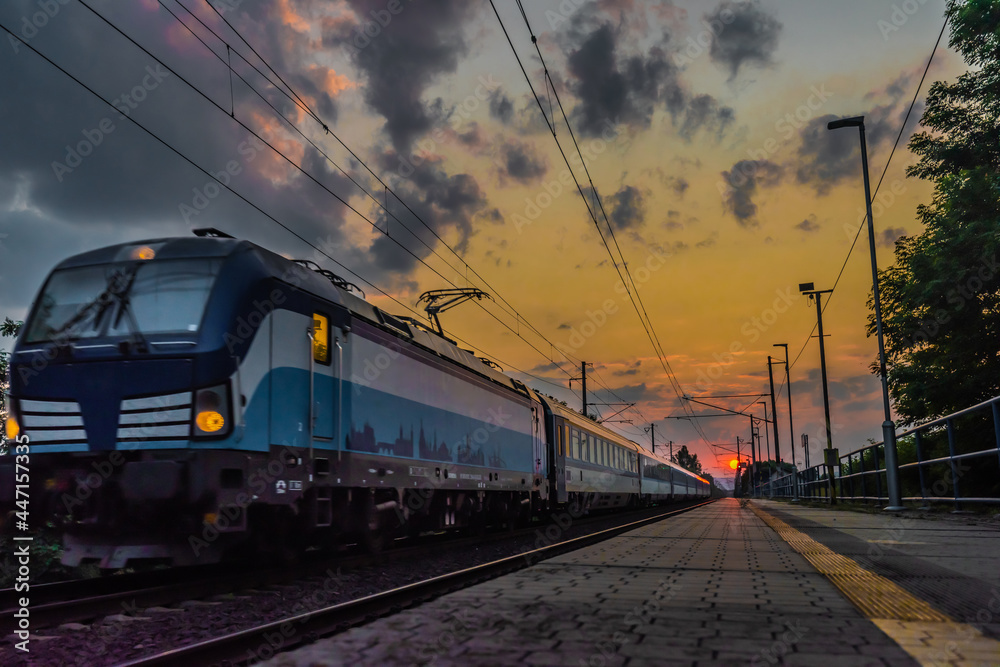 Trains and whistle stop Olesko in central Bohemia in sunset orange evening