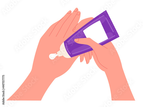 Young woman applies a nourishing cream to her hands