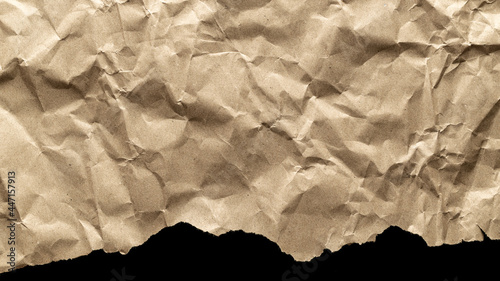 Torn craft. Kraft paper texture background. Old craft vintage cardboard isolated on black. For designs, decoration and nature background concept.