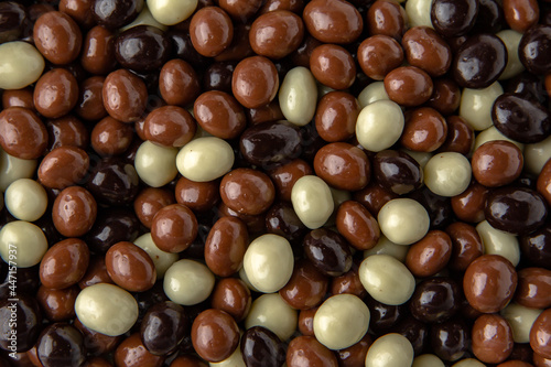Candies. Assorted hazelnuts in dark, milk and white chocolate. Desserts for candy bars. Small dragees