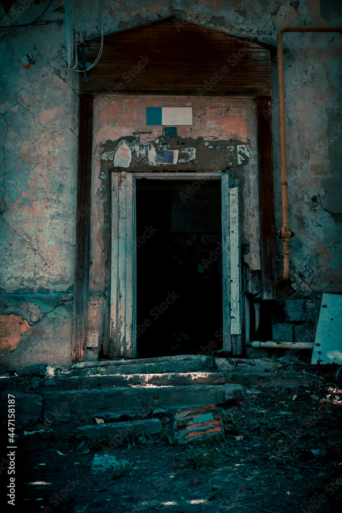 Scary grunge background in horror style, an open door entrance to a dangerous staircase of an old house, steps and stairs to a mystical abandoned ruined dirty dark basement, a feeling of fear