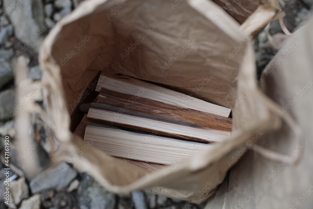 Kindling in a craft paper bag, top view