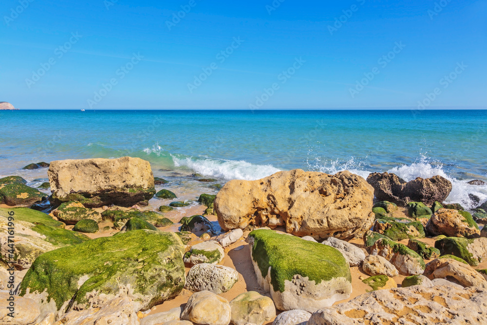 Atlantic coast with stones, sand and clear water.