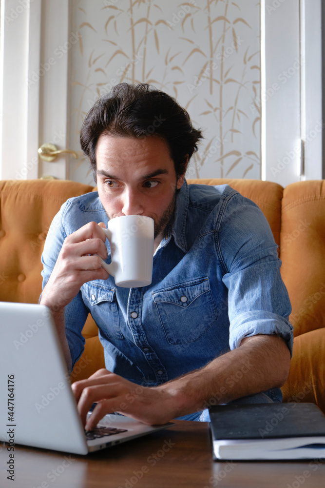Single male, drinking his coffee and doing his online jobs Single male, drinking his coffee and doing his online jobs