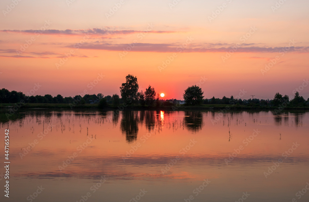Colourful sunset over the ponds reflected in the water