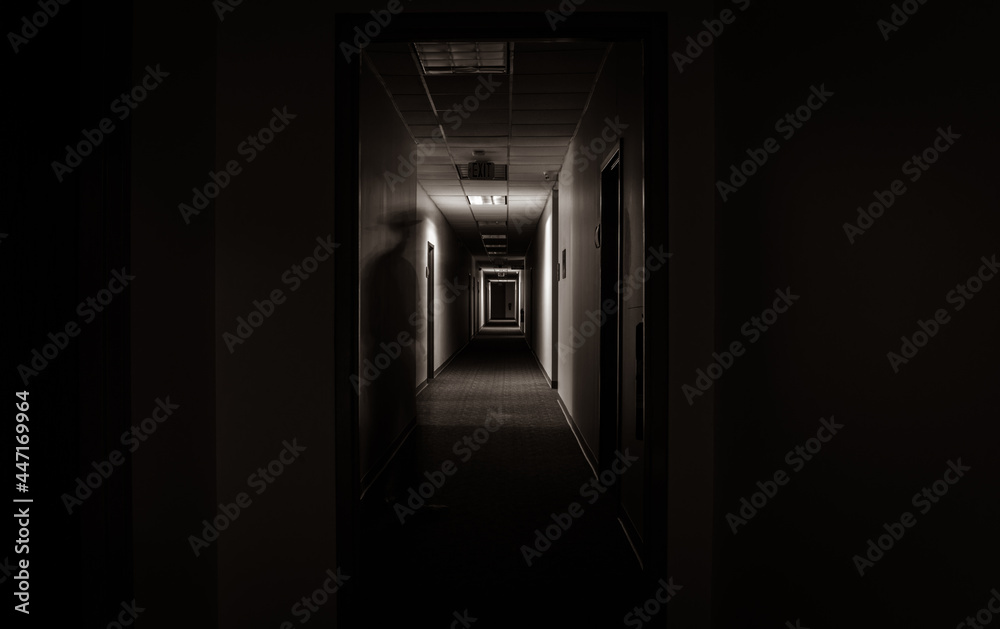 Ghostly specter along the wall in a long dark office corridor. Ghostly specter along the wall in a long dark office corridor.