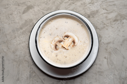 Cream of mushroom soup on grey background. Vegetarian food