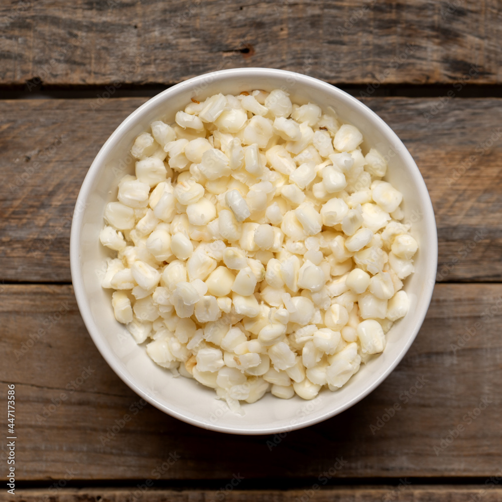 White hominy for mexican pozole on wooden background White hominy for mexican pozole on wooden background
