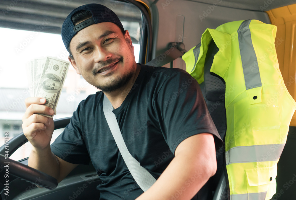© Nuad Contributor - happy smiling asian men owner truck driver holding banknote Wage transportation Currency US dollar © Nuad Contributor - happy smiling asian men owner truck driver holding banknote Wage transportation Currency US dollar