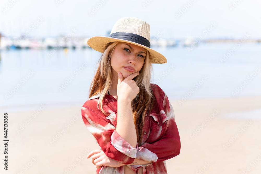 Young pretty woman in summer holidays at beach thinking