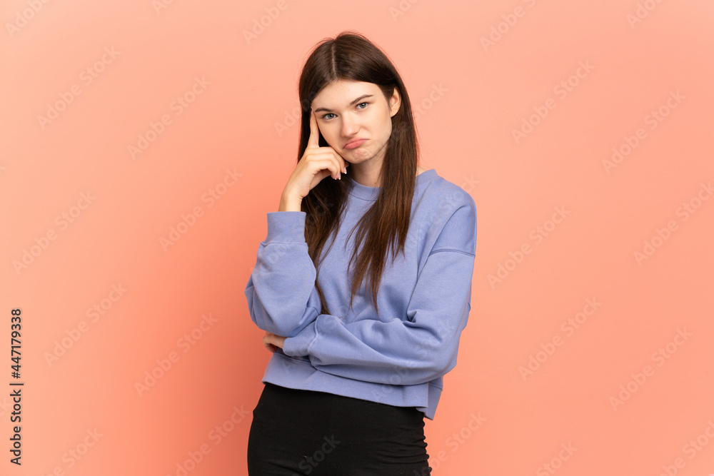 Young Ukrainian girl isolated on pink background thinking an idea Young Ukrainian girl isolated on pink background thinking an idea