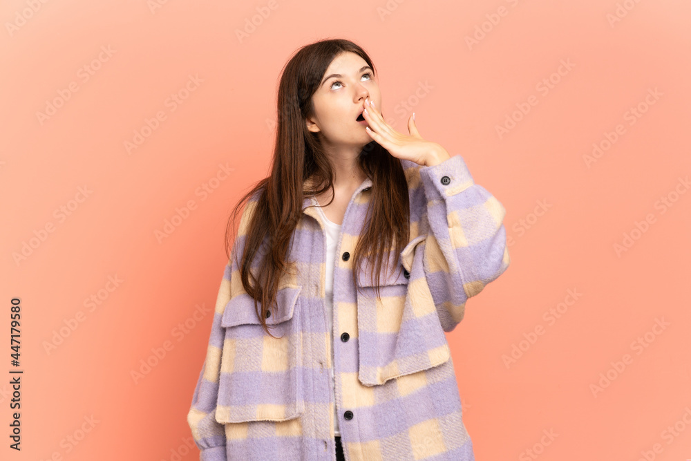 Young Ukrainian girl isolated on pink background yawning and covering wide open mouth with hand Young Ukrainian girl isolated on pink background yawning and covering wide open mouth with hand