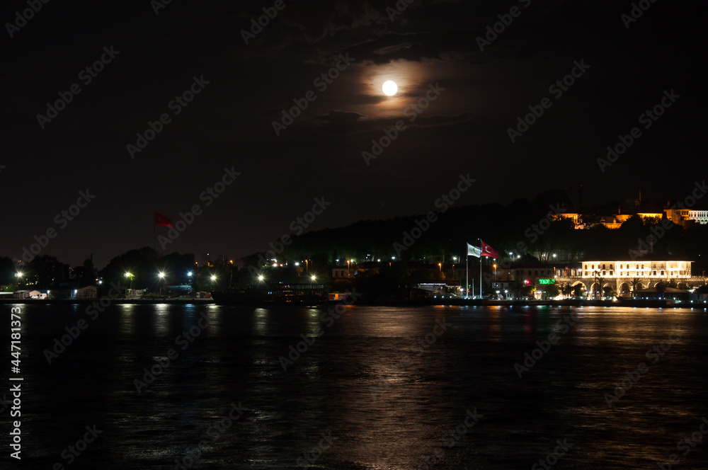 Night lights on Hagia Sophia under a full moon at twilight in Istanbul Turkey