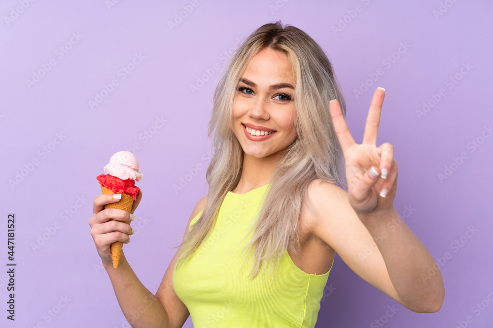 Teenager girl over isolated purple background smiling and showing victory sign Teenager girl over isolated purple background smiling and showing victory sign