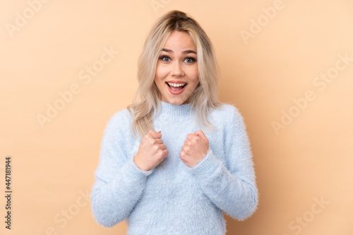Teenager girl over isolated background celebrating a victory