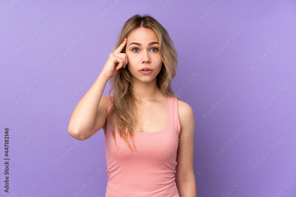 Teenager Russian girl isolated on purple background thinking an idea Teenager Russian girl isolated on purple background thinking an idea