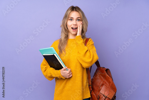 Teenager Russian student girl isolated on purple background with surprise and shocked facial expression
