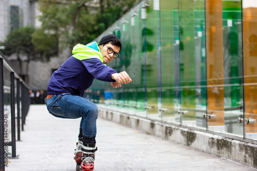 Young adult man skating on the street