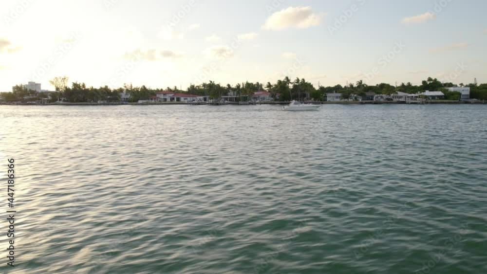 Aerial view towards a boat on the coastline of Miami beach, golden hour in Florida - circling, drone shot Aerial view towards a boat on the coastline of Miami beach, golden hour in Florida - circling, drone shot