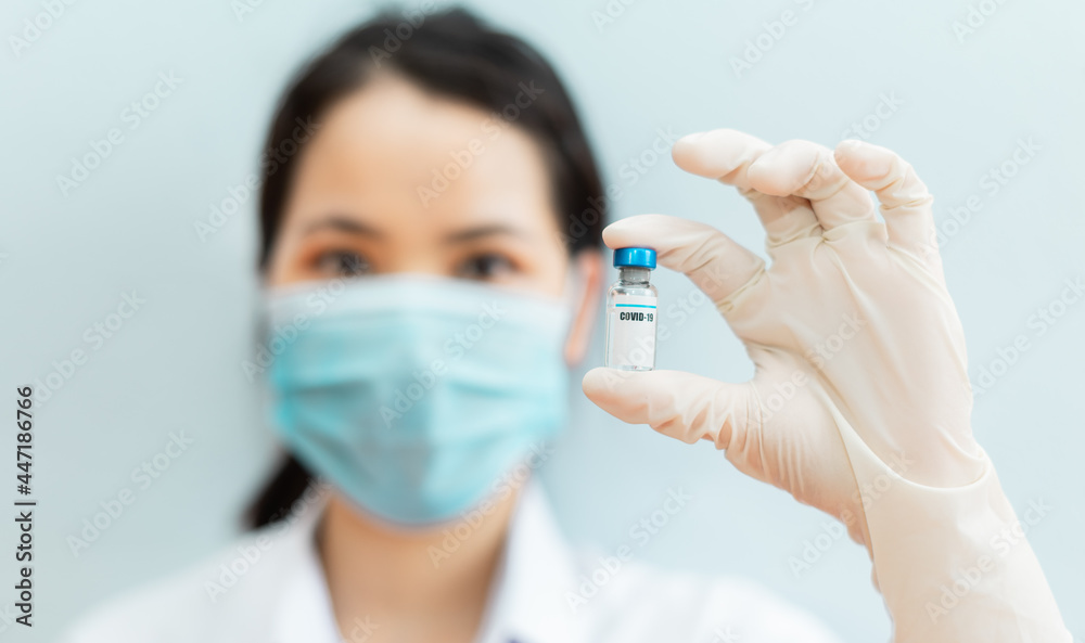 image of a female nurse holding a covid 19 vaccine image of a female nurse holding a covid 19 vaccine
