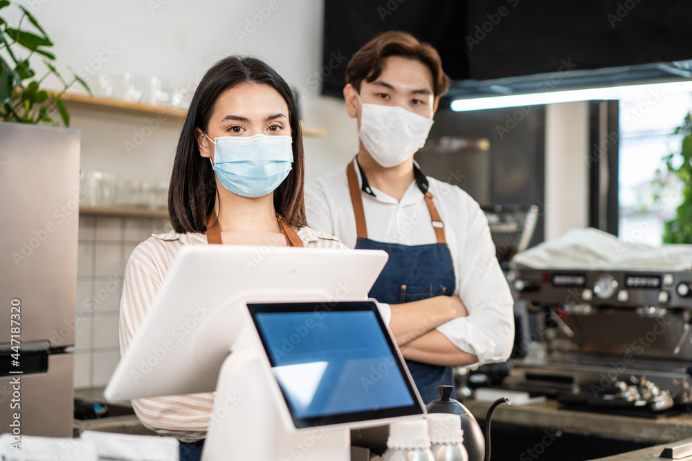 Portrait of attractive Asian waiter and waitress at restaurant cafe. Portrait of attractive Asian waiter and waitress at restaurant cafe.