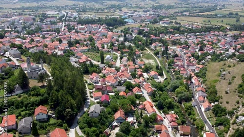 Aerial drone view of Livno, Bosnia and Herzegovina. Buildings, streets and residential houses, view from above. Livanjsko polje surrounded by mountains. photo