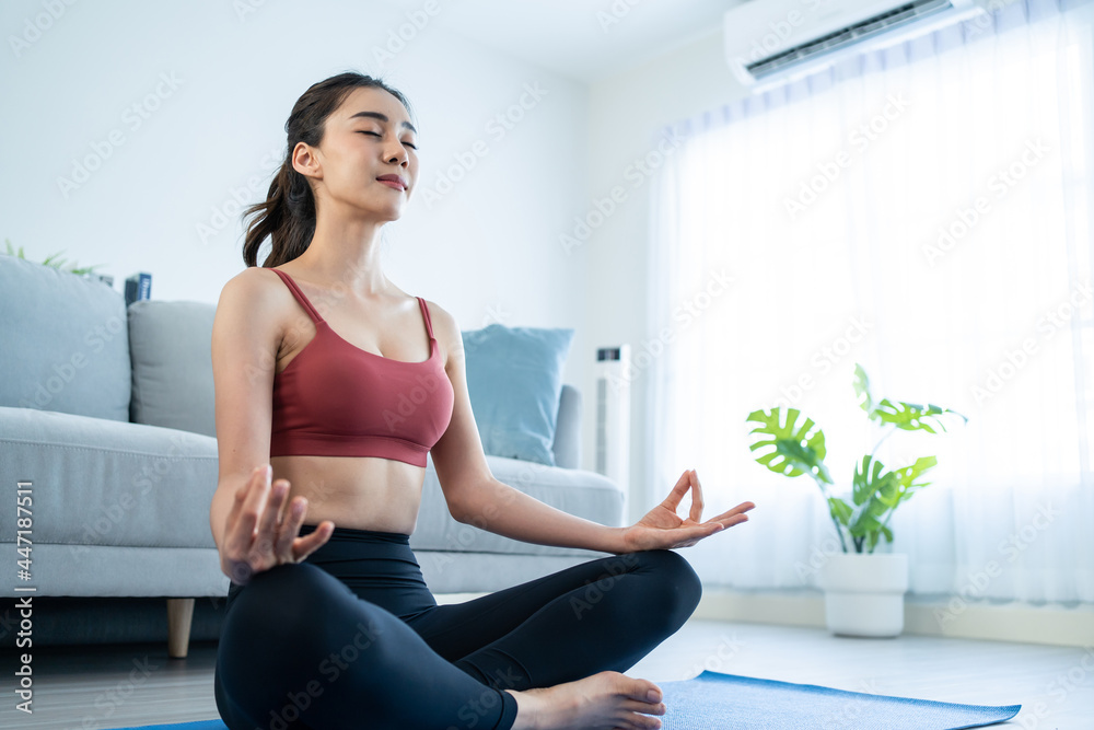 Asian Beautiful young woman stay home, doing yoga exercise at home. 