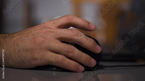 hand of a man working, clicking on a button mouse photo