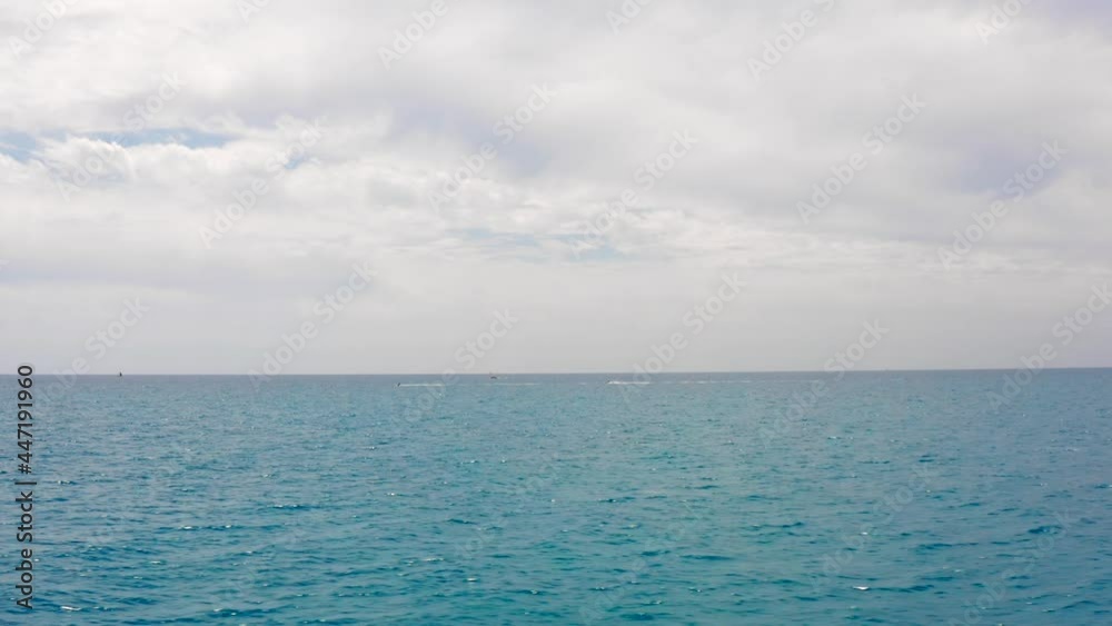 Distant View Of Jetski At The Blue Ocean Under Cloudy Sky. tracking shot Distant View Of Jetski At The Blue Ocean Under Cloudy Sky. tracking shot