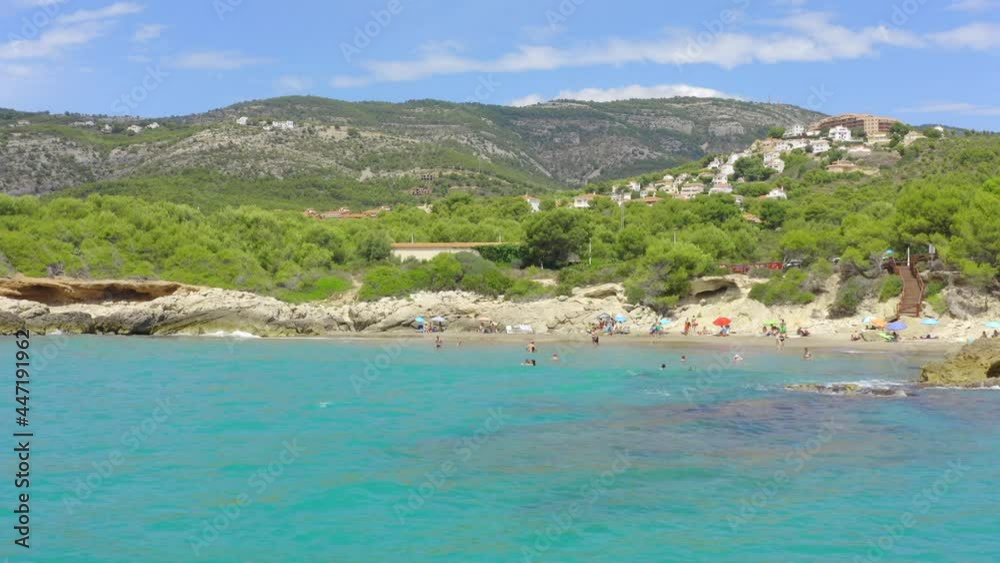 Mediterranean coast with rocky beach and mountain range in Spain, panoramic shot from moving boat Mediterranean coast with rocky beach and mountain range in Spain, panoramic shot from moving boat