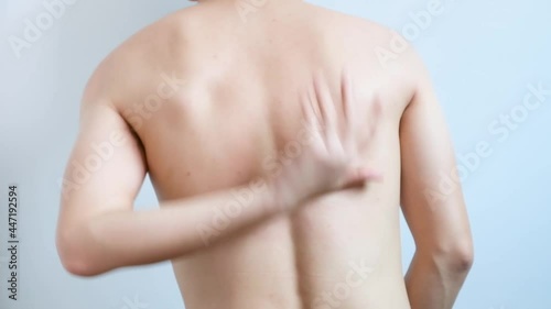 The man's hands he uses his hands to scratch his back because of dermatitis and itch sensation.