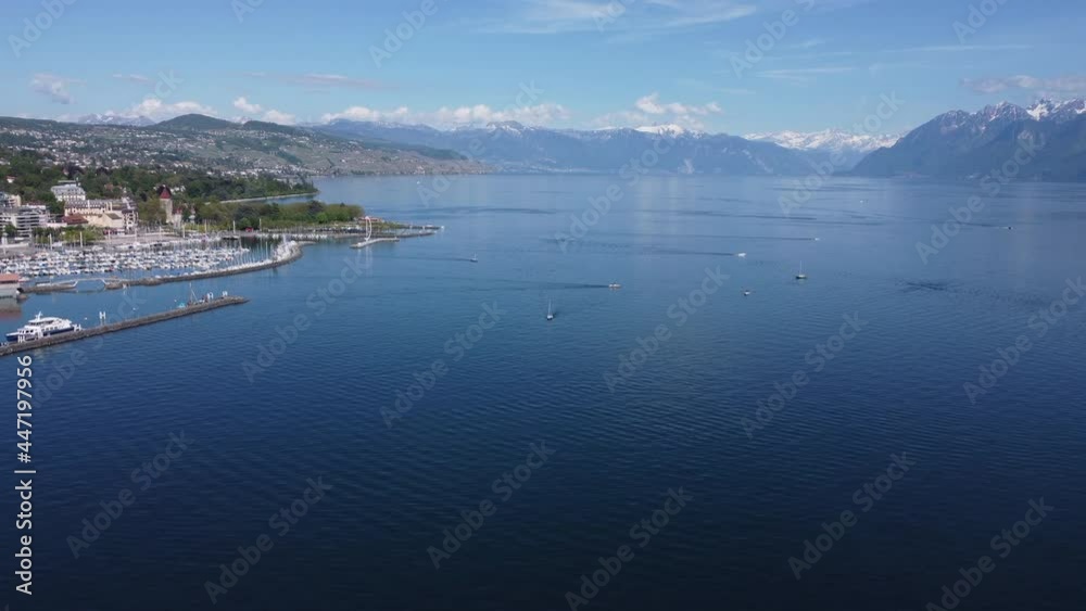 Slow aerial descent shot of a sail boat on Lake Geneva in Lausanne, Switzerland on a sunny day. Slow aerial descent shot of a sail boat on Lake Geneva in Lausanne, Switzerland on a sunny day.