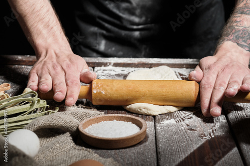 Chef making fresh dough with rolling pin © sata_production