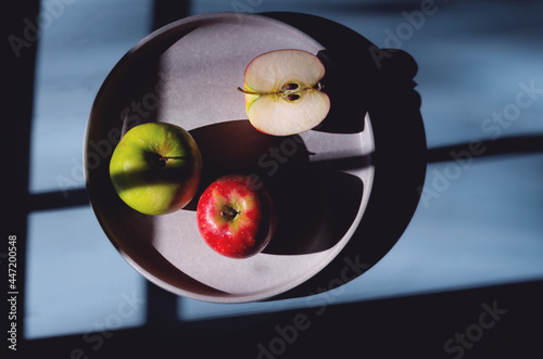 Trio of apples on a blue background.