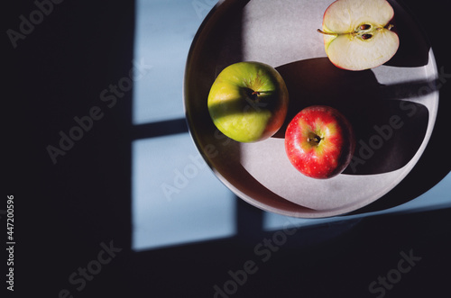 Trio of apples on a blue background.